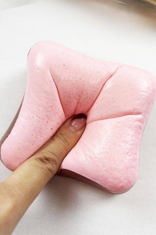 Scented Slow Rising Toast Squishy Toy in pink, white, and yellow