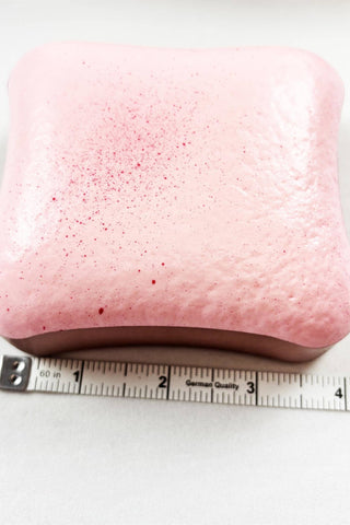 Scented Slow Rising Toast Squishy Toy in pink, white, and yellow