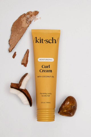 Kit-sch Curl Cream tube with coconut pieces on a light gray background
