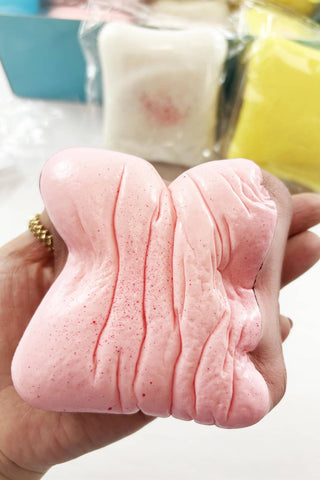 Scented Slow Rising Toast Squishy Toy in pink, white, and yellow
