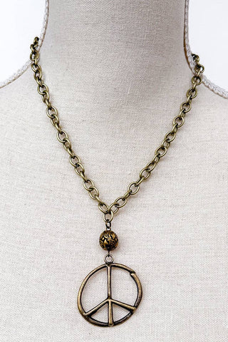 Bronze Necklace with peace symbol pendant on a mannequin bust
