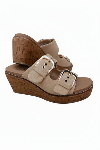 A pair of women's wedge sandals in beige suede with double adjustable buckles and a cork-look wedge heel, shown on a white background.
