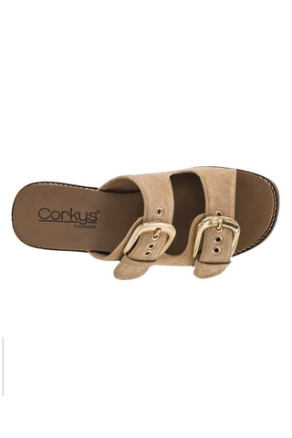 A single Conkys double-strap slide sandal in beige suede with gold-tone buckle details, shown from a top-down view on a white background.