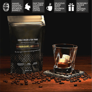 Bourbon barrel aged coffee package with a glass of whiskey on a wooden surface.