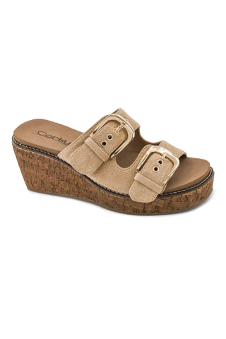 A single women's wedge slide sandal in beige suede-like material with two wide straps and gold-tone buckles, shown on a plain white background. The brand name 'Corkys' is visible on the insole.