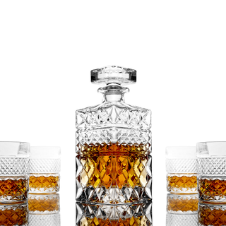 Crystal whiskey decanter with glasses on a white background