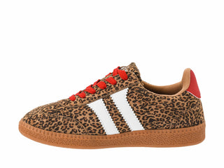 A low-top sneaker featuring a brown and black leopard print upper, white side stripes, red laces, and a brown gum sole, shown against a plain white background.