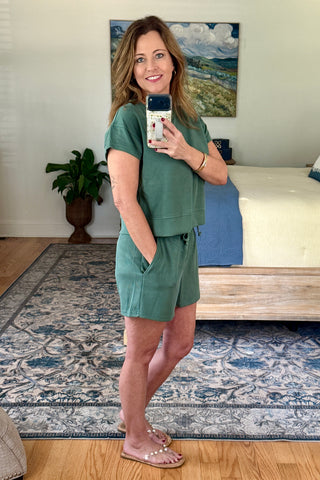 Woman taking a mirror selfie wearing a lounge set.