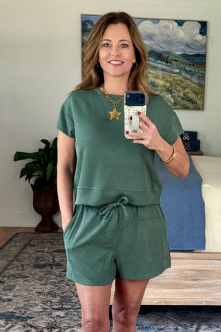 Woman taking a mirror selfie wearing a lounge set.