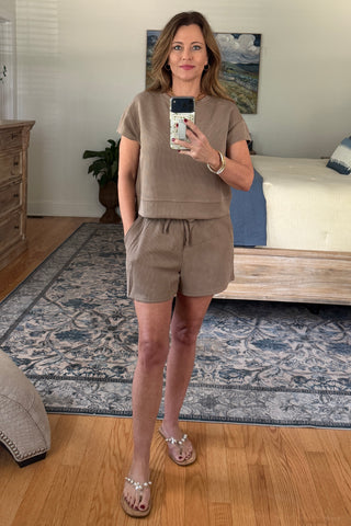 Woman taking a mirror selfie wearing a lounge set.