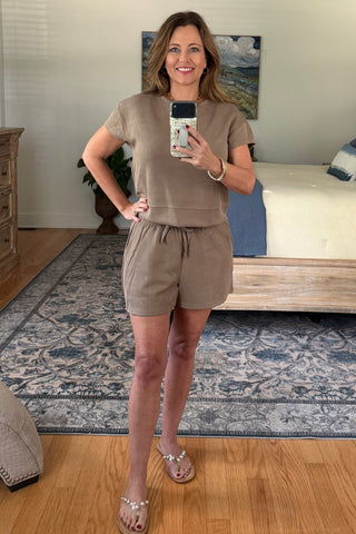 Woman taking a mirror selfie wearing a lounge set.