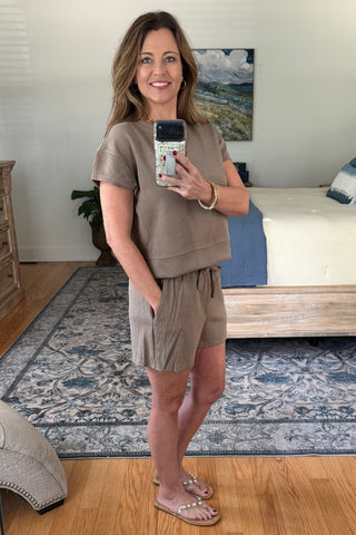 Woman taking a mirror selfie wearing a lounge set.