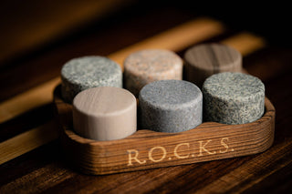 Set of round stone tablets in a wooden holder with 'R.O.C.K.S.' branding on a wooden surface.