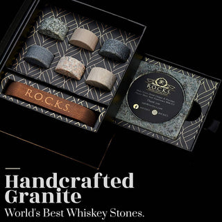 Handcrafted granite whiskey stones in a decorative box with 'R.O.C.K.S.' branding.