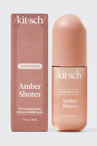Kit-sch Amber Shores hair perfume bottle and packaging on a light gray background