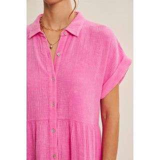 Pink cotton guaze dress closeup worn by a person on a plain background
