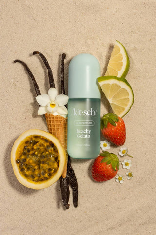 Kitsch product with vanilla beans, lemon slices, strawberries, and a flower on a beige background