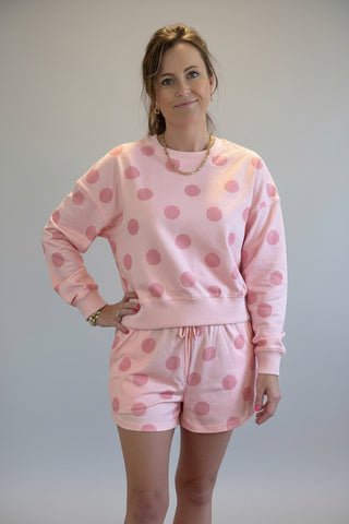 Woman wearing a pink polka dot lounge short set 