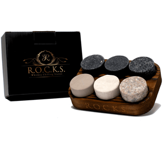 Set of whiskey stones with a wooden tray and branded box on a white background